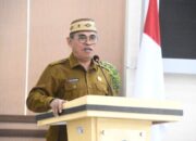 Sekda Bone Bolango, Iwan Mustapa saat memberikan sambutan sekaligus membuka kegiatan Sosialisasi Pencegahan Kekerasan Terhadap Perempuan dan Anak yang Diintegrasikan dengan Pemeriksaan Kesehatan yang digelar di Aula BPMP Provinsi Gorontalo, Selasa (5/8/2025). (F.AKP-Tim Redaksi Diskominfo)/Ulanda.id