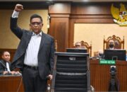 Terdakwa kasus dugaan suap pengganti antarwaktu (PAW) untuk anggota DPR Harun Masiku dan kasus perintangan penyidikan, Hasto Kristiyanto (kanan), mengangkat tangannya sebelum menjalani sidang pembacaan vonis di Pengadilan Tipikor, Jakarta, Jumat (25/7/2025). ANTARA FOTO/Bayu Pratama S/app/foc.